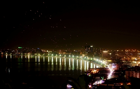 Hundreds of khomloys float up into the night sky from Pattaya Beach, as over 100,000 tourists and residents celebrate Loy Krathong, sending all their worries soaring away on the most romantic holiday on the Thai calendar. Despite what international media might be proclaiming, Pattaya has not been inundated with flood waters and remains a great holiday spot. (Photo by Martin Bilsborrow)